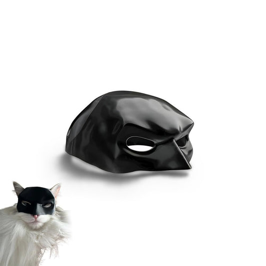 white cat wearing a bat cat mask